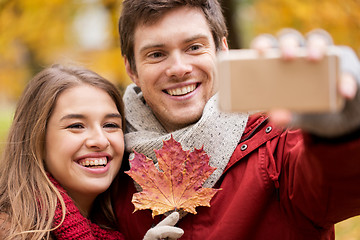 Image showing couple taking selfie by smartphone in autumn park