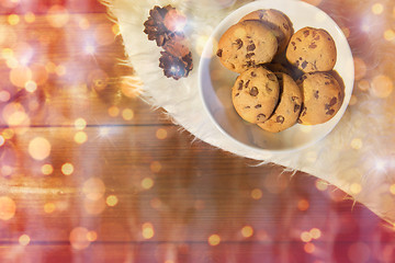 Image showing christmas cookies in bowl and cones on fur rug