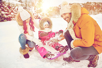 Image showing happy family with kid on sled having fun outdoors