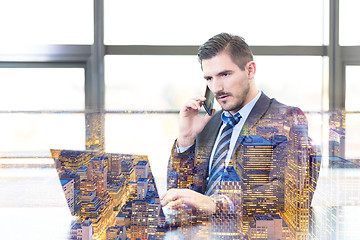 Image showing Businessman in office working on laptop computer.