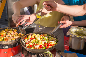 Image showing Cheff cooking traditional Mediterranean octopus on street stall.