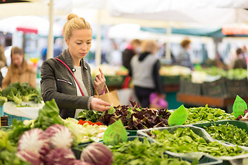 Image showing Woman buying vegetable at local food market. 