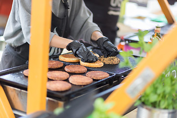 Image showing Beef burgers ready to serve on food stall.