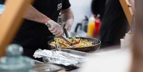 Image showing Cheff cooking on outdoor street food festival.