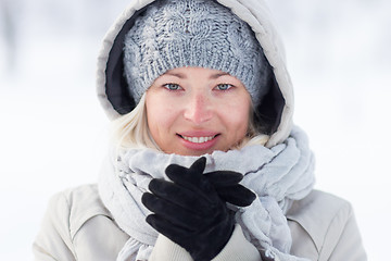 Image showing Girl beeing cold outdoors in winter.