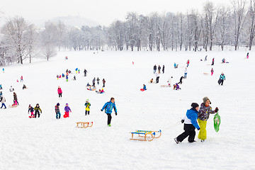 Image showing Winter fun, snow, family sledding at winter time.