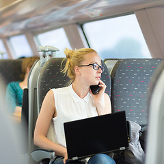 Image showing Business woman working while travelling by train.