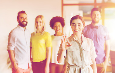 Image showing happy woman showing ok over creative office team