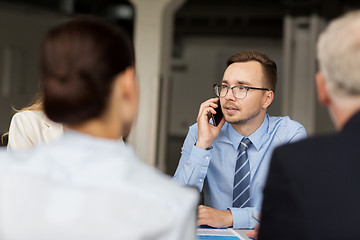 Image showing businessman calling on smartphone at office