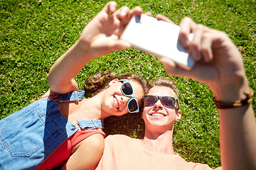 Image showing happy couple taking selfie on smartphone at summer