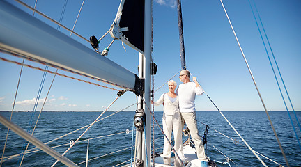 Image showing senior couple hugging on sail boat or yacht in sea