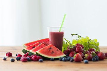 Image showing fruit and berry juice or smoothie on wooden  table