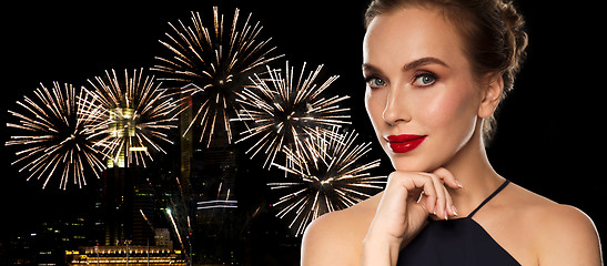 Image showing beautiful woman in black over firework lights