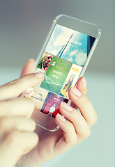 Image showing close up of woman with news pages on smartphone