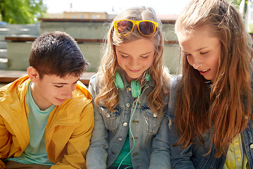 Image showing three happy teenage friends headphones