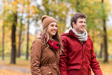 Image showing happy young couple walking in autumn park