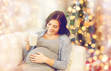 Image showing happy pregnant woman with cup drinking tea at home