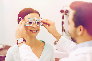 Image showing optician with trial frame and patient at clinic