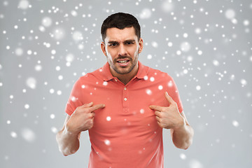 Image showing angry man pointing finger to himself over snow