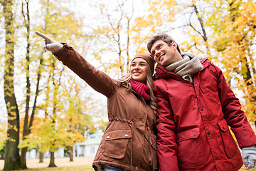 Image showing happy young couple walking in autumn park