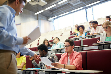 Image showing teacher giving tests to students at lecture