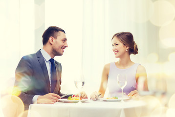 Image showing smiling couple eating main course at restaurant