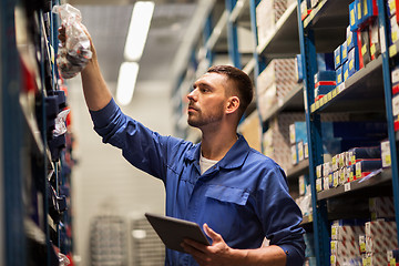 Image showing auto mechanic or smith with tablet pc at workshop