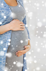 Image showing close up of pregnant woman belly and hands