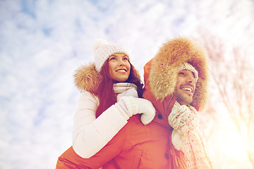 Image showing happy couple having fun over winter background