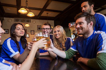 Image showing football fans clinking beer glasses at sport bar