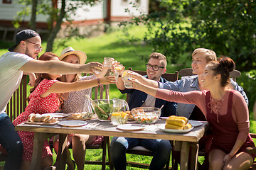 Image showing happy friends having dinner at summer garden party