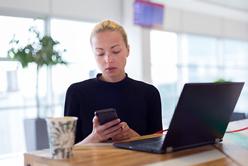 Image showing Female freelancer remotely working on the go.