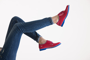 Image showing Woman\'s Legs In Blue Jeans And Red Shoes