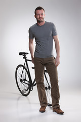 Image showing Young Man And Bicycle