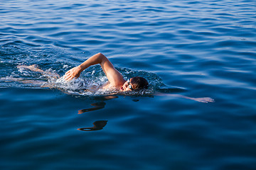 Image showing Man swimming in blue water