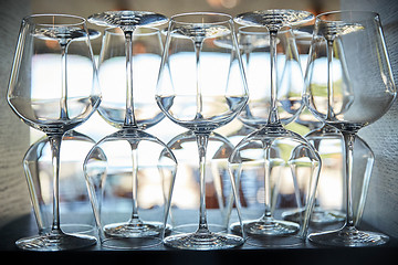 Image showing empty wine glasses set on shelf at restaurant