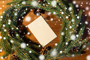 Image showing natural green fir wreath with note on wooden board