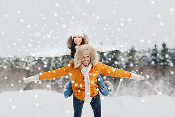 Image showing happy couple having fun over winter background