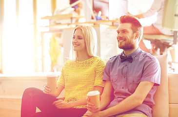 Image showing happy man and woman drinking coffee in office