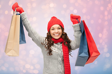 Image showing woman with shopping bags over christmas lights 