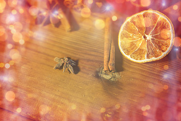 Image showing cinnamon, anise and dried orange on wooden board