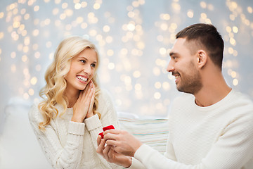 Image showing happy man giving engagement ring to woman