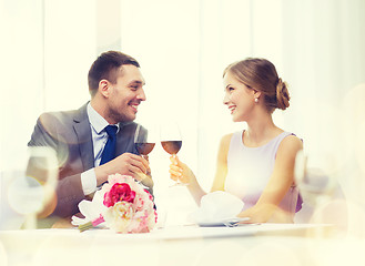 Image showing young couple with glasses of wine at restaurant