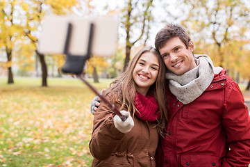 Image showing couple taking selfie by smartphone in autumn park