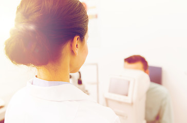 Image showing close up of optician and patient at eye clinic