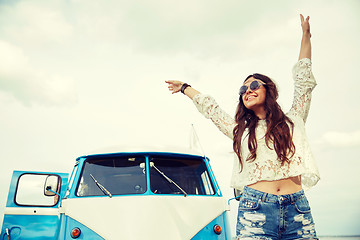 Image showing smiling young hippie woman in minivan car