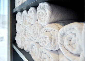Image showing rolled white bath towels at hotel spa