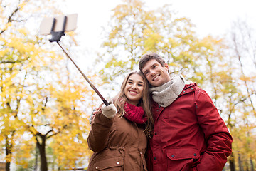 Image showing couple taking selfie by smartphone in autumn park