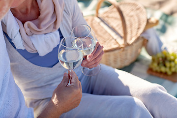 Image showing happy senior couple having picnic on summer beach