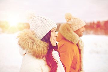 Image showing happy couple walking over winter background